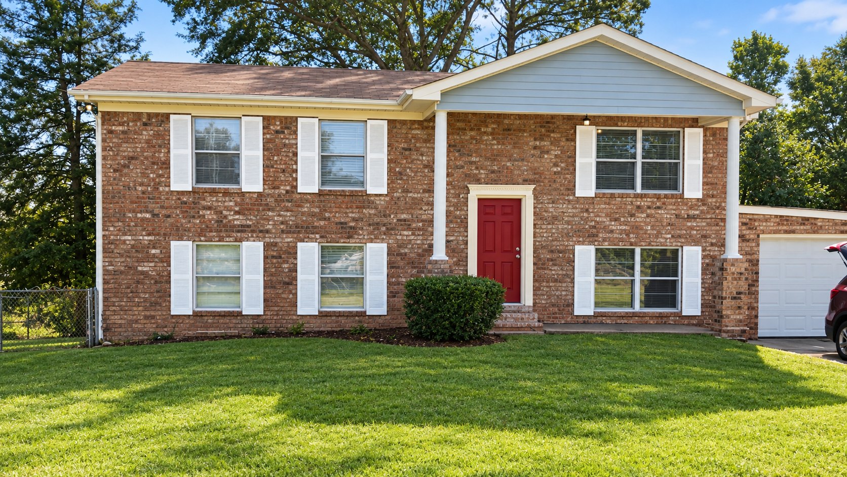 Digitally enhanced photo of the actual FOCUS House exterior in Augusta, Georgia, showing proposed white shutters, cream entry trim, and crimson entry door